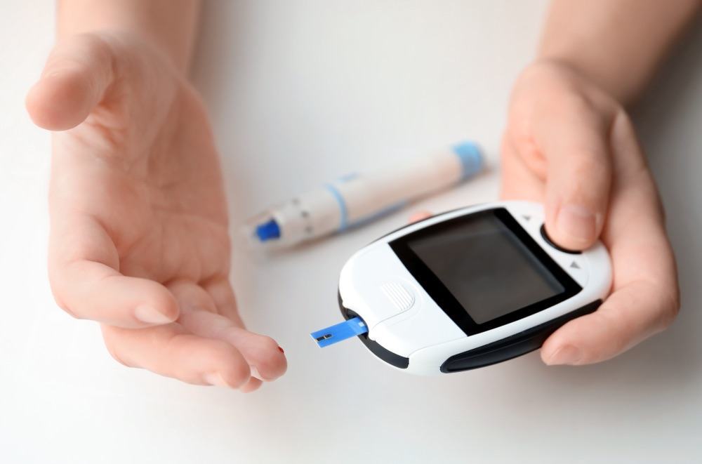 testing blood glucose levels with blood glucose meter